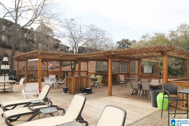 wooden terrace with outdoor dining area and a pergola