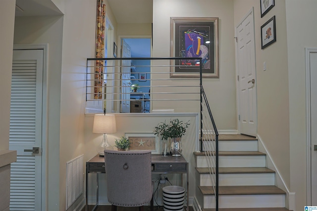 stairway featuring visible vents and baseboards