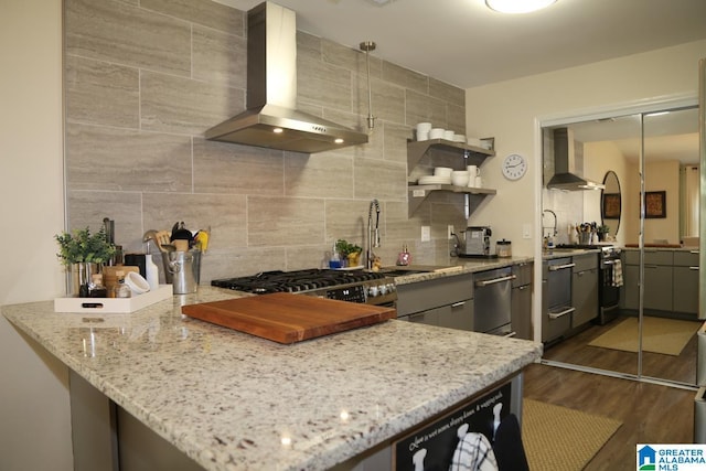 kitchen with backsplash, exhaust hood, wood finished floors, wall chimney exhaust hood, and open shelves