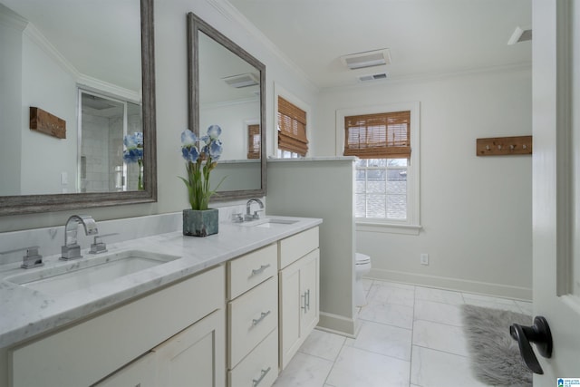 full bathroom featuring crown molding, toilet, and a sink