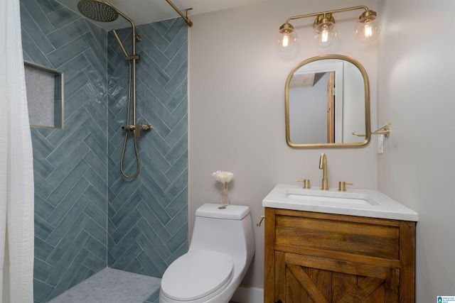 full bathroom with vanity, toilet, and tiled shower