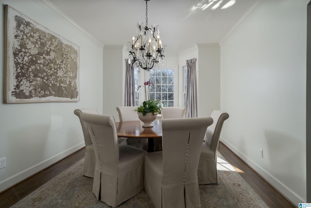 dining room featuring a chandelier, baseboards, wood finished floors, and ornamental molding