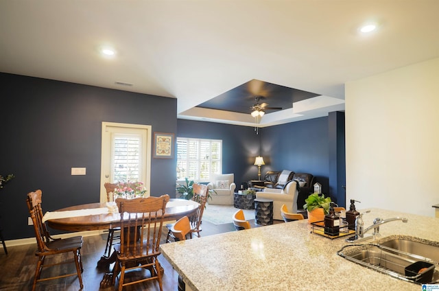 dining space with ceiling fan, a tray ceiling, visible vents, and recessed lighting