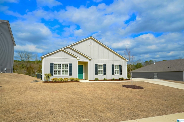 view of front of property featuring central air condition unit, board and batten siding, and a front yard