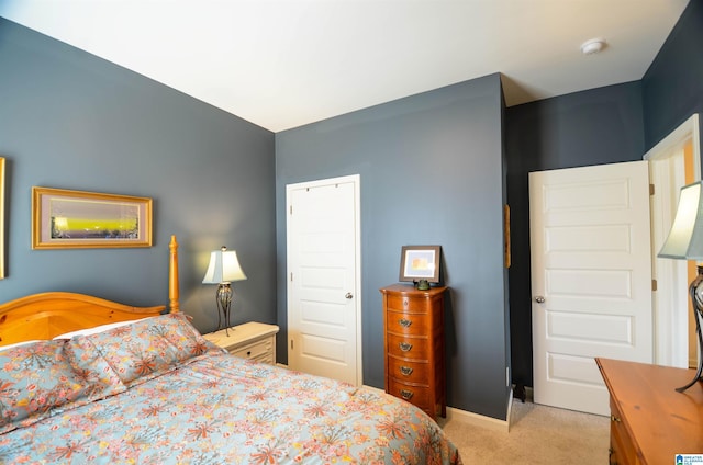 bedroom featuring baseboards and light colored carpet