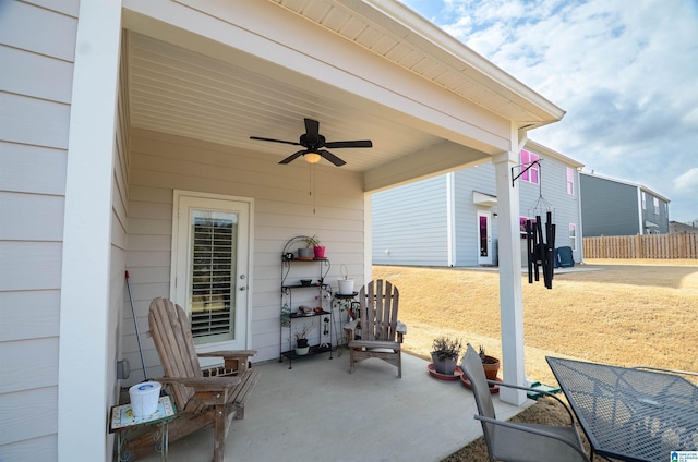 view of patio featuring ceiling fan and fence