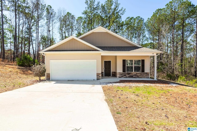 view of front of house with a garage, stone siding, driveway, and a porch