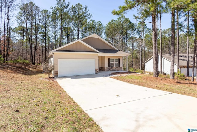 view of front facade featuring concrete driveway, stone siding, and an attached garage