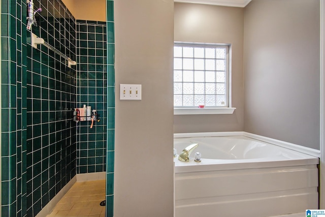 bathroom featuring tiled shower and a bath