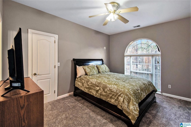 bedroom featuring baseboards, visible vents, and dark colored carpet