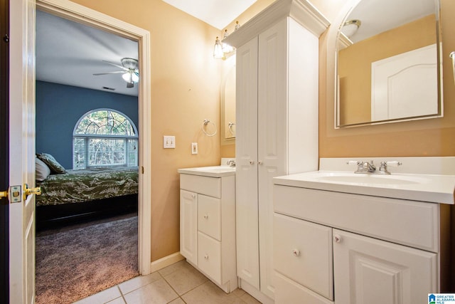 bathroom with vanity, a ceiling fan, baseboards, ensuite bathroom, and tile patterned floors