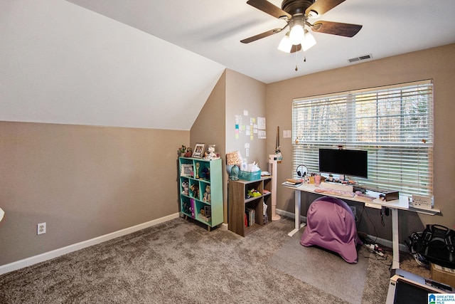 carpeted office featuring visible vents, baseboards, lofted ceiling, and a ceiling fan