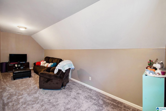 sitting room with vaulted ceiling, baseboards, and carpet floors