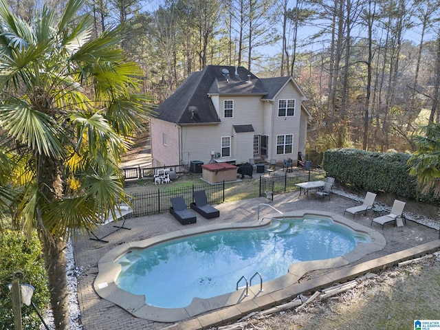 view of swimming pool featuring a patio area, a fenced in pool, and fence