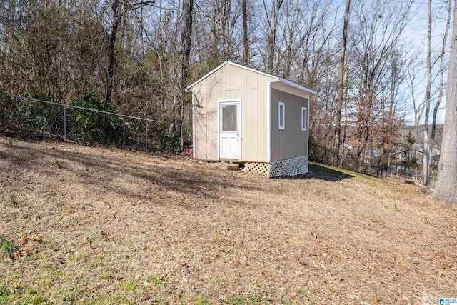 view of shed featuring fence