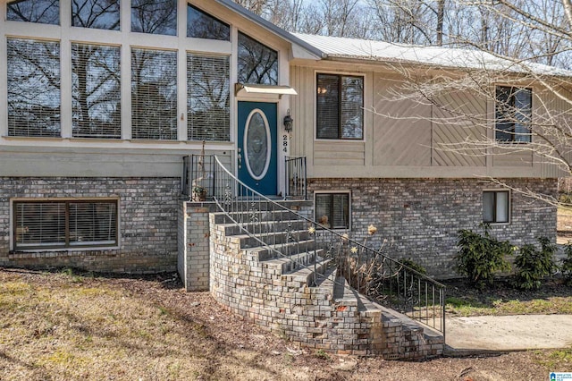 doorway to property with brick siding