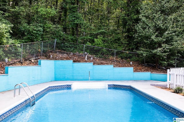 view of swimming pool featuring fence and a fenced in pool