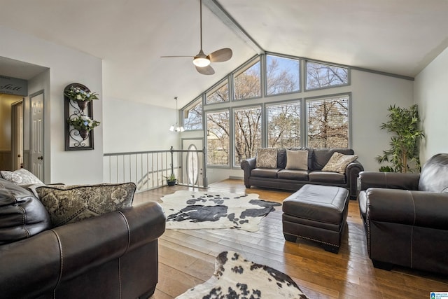 living area featuring wood-type flooring, high vaulted ceiling, and a wealth of natural light