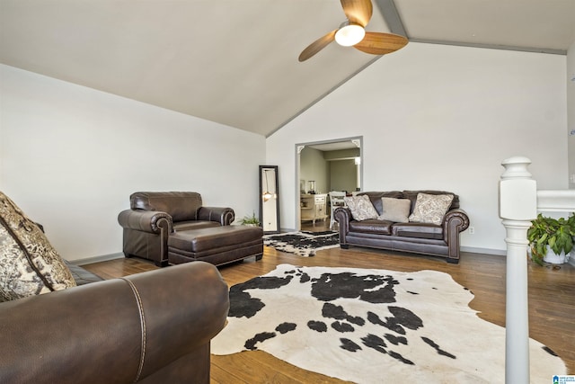 living room with high vaulted ceiling, ceiling fan, baseboards, and wood finished floors