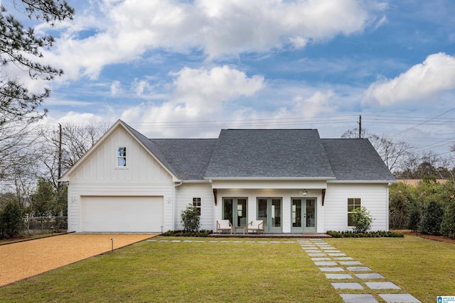 modern inspired farmhouse with board and batten siding, a front lawn, roof with shingles, french doors, and driveway