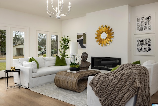 living room featuring wood finished floors and a chandelier