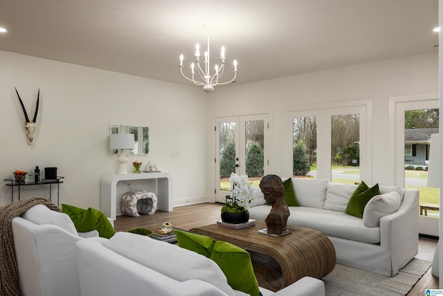 living room featuring an inviting chandelier, recessed lighting, wood finished floors, and a healthy amount of sunlight