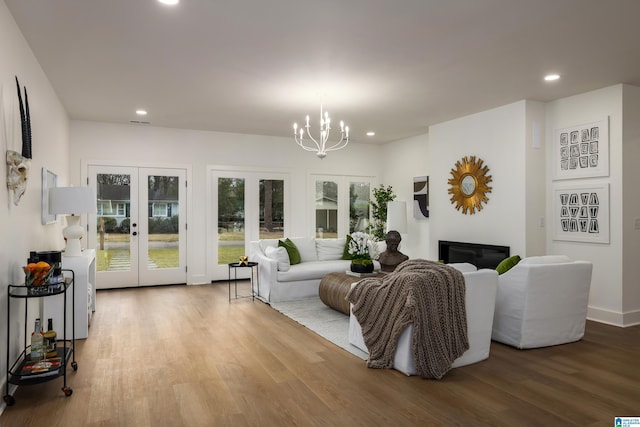 living room with recessed lighting, french doors, and wood finished floors