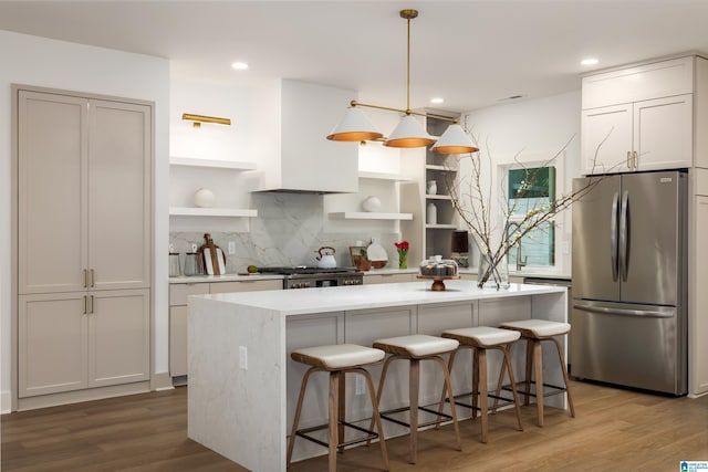 kitchen with tasteful backsplash, light countertops, light wood-style flooring, freestanding refrigerator, and open shelves