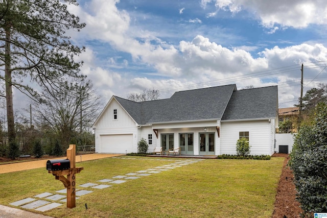 modern inspired farmhouse featuring a front lawn, roof with shingles, french doors, a garage, and driveway