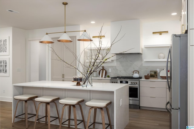 kitchen with visible vents, dark wood-style flooring, extractor fan, white cabinets, and appliances with stainless steel finishes