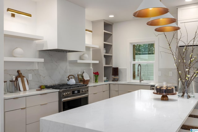 kitchen featuring open shelves, tasteful backsplash, a sink, and gas stove