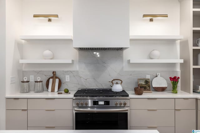 kitchen with open shelves, modern cabinets, backsplash, and stainless steel gas range oven