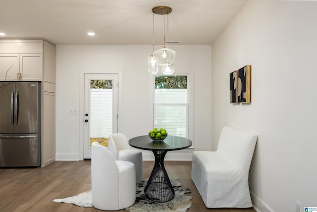 dining area featuring recessed lighting, baseboards, and wood finished floors