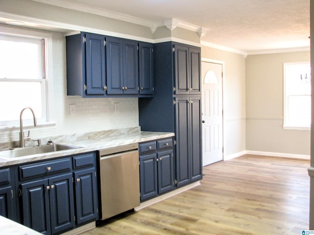 kitchen with light countertops, blue cabinetry, decorative backsplash, dishwasher, and a sink