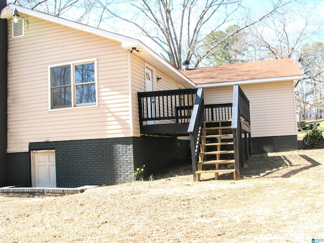 view of home's exterior featuring stairs and a deck