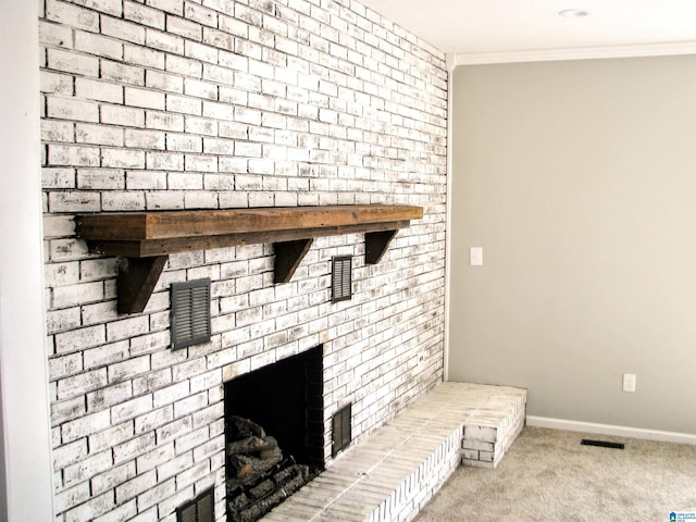 interior details with visible vents, baseboards, ornamental molding, a fireplace, and carpet floors