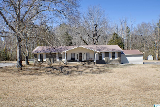 view of front facade featuring a porch, a front yard, and brick siding