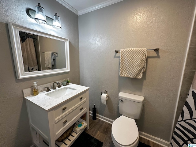 full bath featuring a textured wall, toilet, wood finished floors, crown molding, and vanity