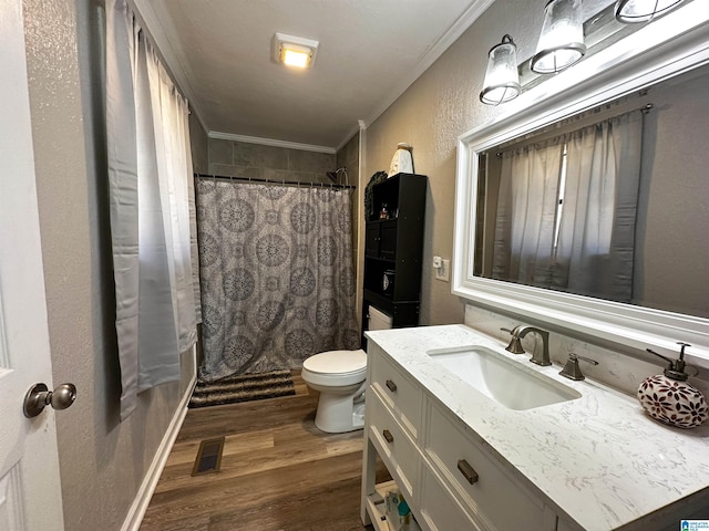 full bathroom with visible vents, toilet, ornamental molding, vanity, and wood finished floors