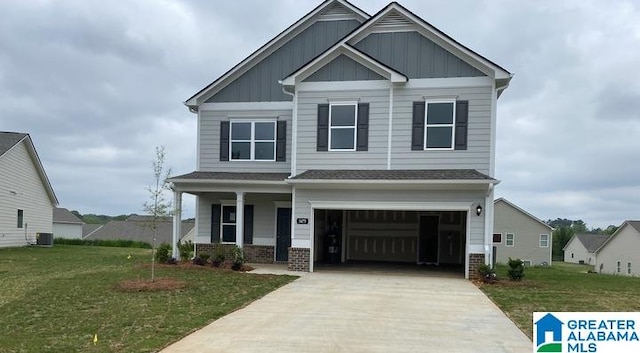 craftsman inspired home with board and batten siding, a front lawn, concrete driveway, cooling unit, and an attached garage