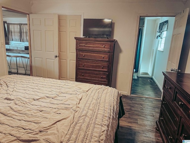 bedroom with dark wood-style flooring and baseboards