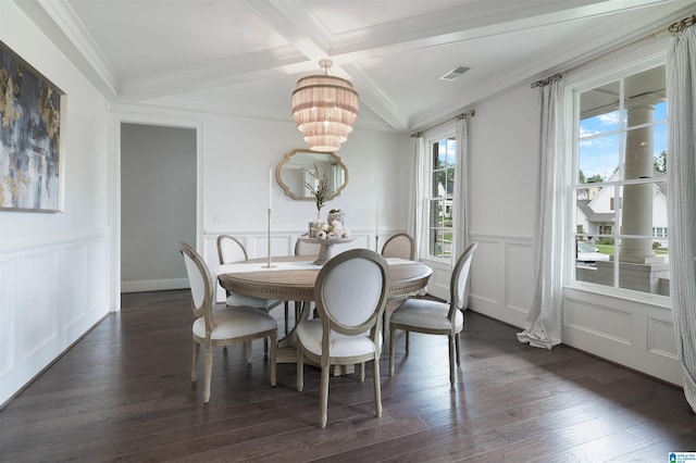 dining area featuring dark wood-type flooring, a decorative wall, and coffered ceiling