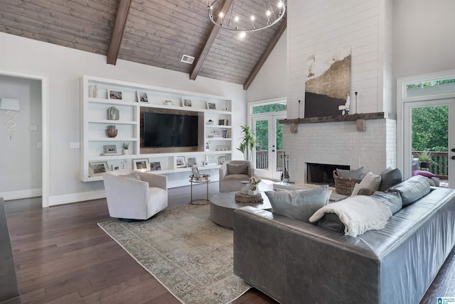 living room with dark wood finished floors, a brick fireplace, a healthy amount of sunlight, and high vaulted ceiling