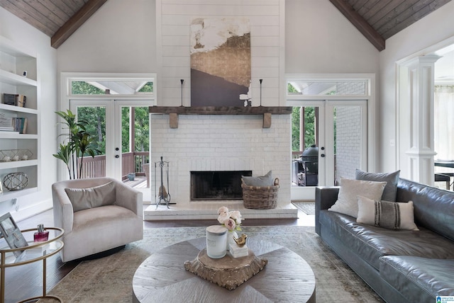 living room featuring plenty of natural light, french doors, wood ceiling, and built in shelves