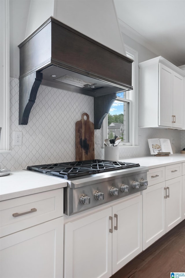 kitchen featuring custom exhaust hood, white cabinets, light countertops, and stainless steel gas cooktop