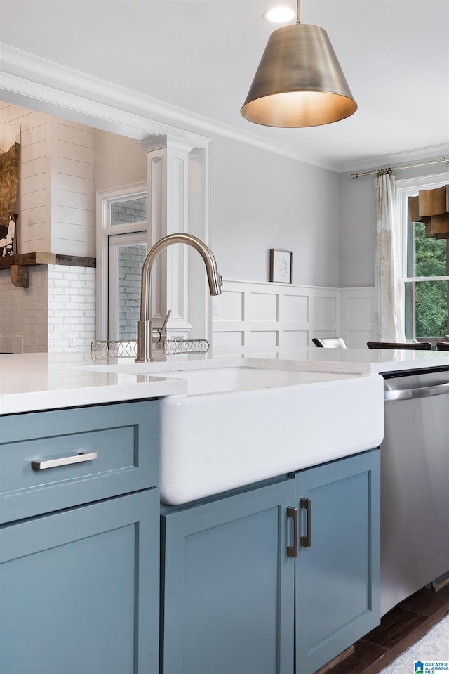 kitchen with decorative backsplash, light countertops, dishwasher, crown molding, and blue cabinets