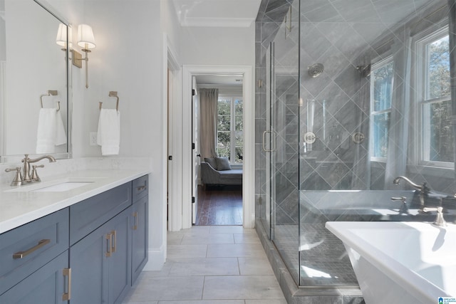 ensuite bathroom with vanity, a freestanding tub, a stall shower, tile patterned floors, and connected bathroom