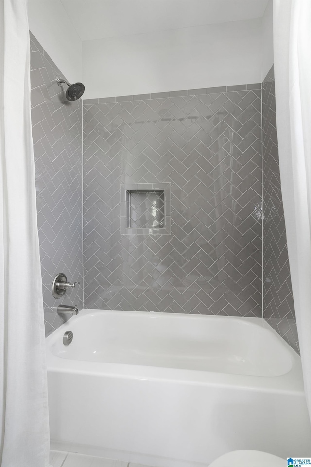 bathroom with shower / bathtub combination with curtain