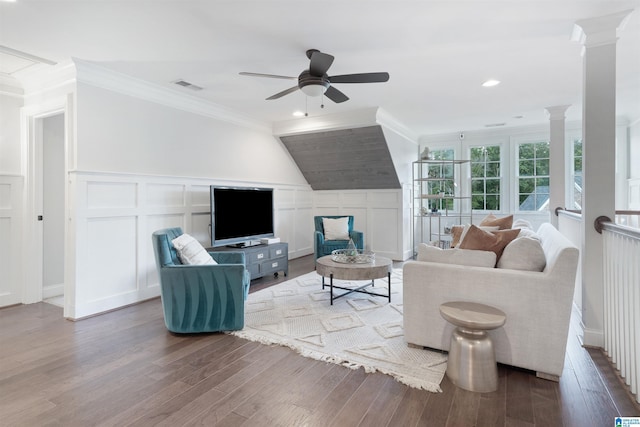 living area featuring visible vents, crown molding, ceiling fan, decorative columns, and wood finished floors