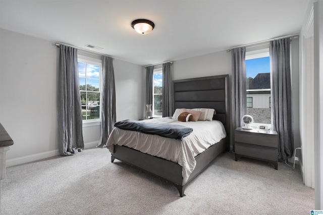 carpeted bedroom featuring visible vents and baseboards